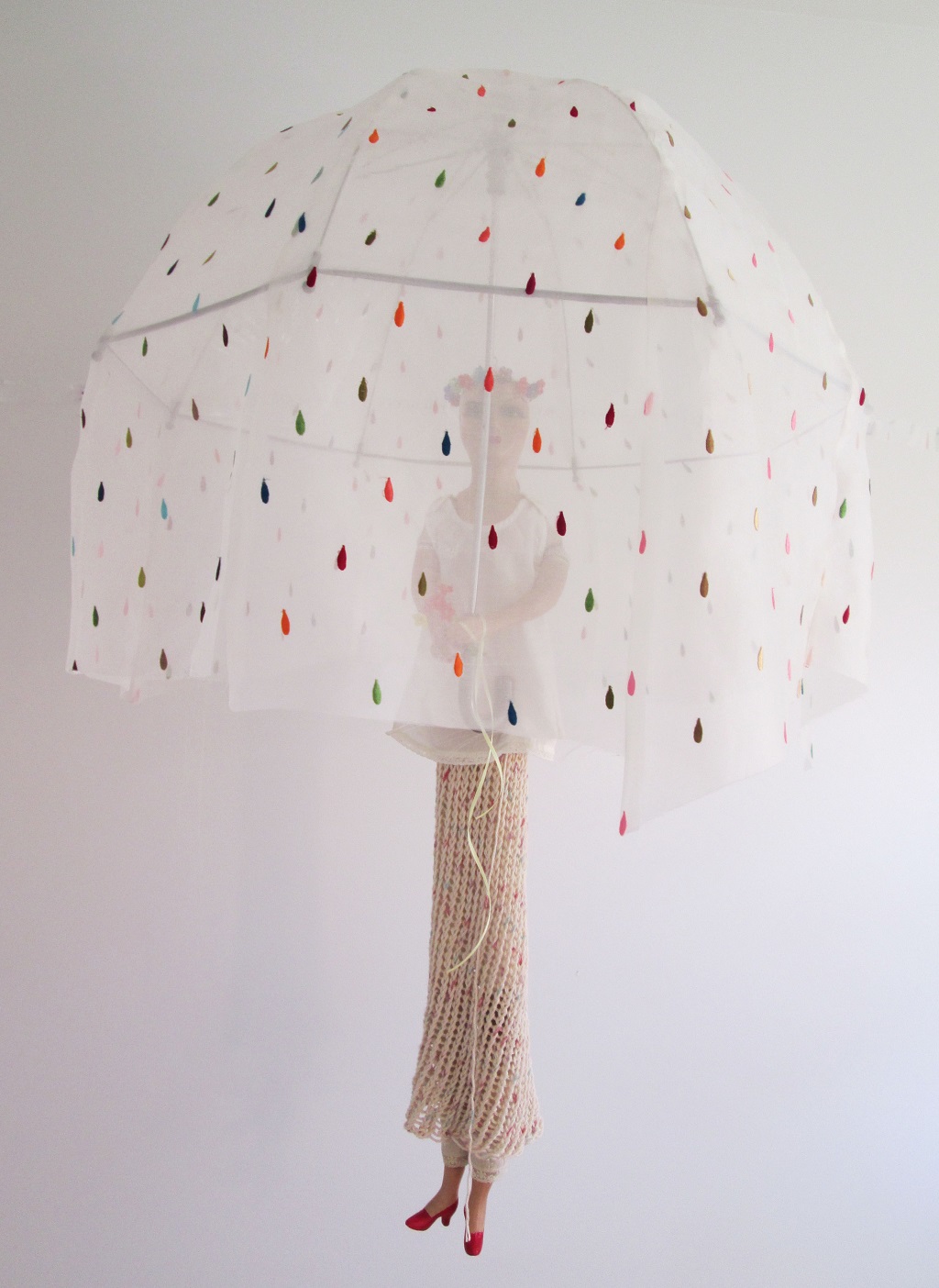 May Child; Old doll and doll clothes, string, umbrella, fabric, glass flowers; 47"h x 30"w x 30"d; 2015