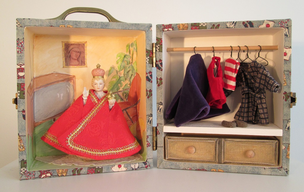 Infant of Prague; Found infant, wood, paper, fabric, hardware; 9"h x 8"w x 6"d (closed); 1997